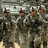 Pixelated image of soldiers in camouflage uniforms with text stating 'We Are A Family We Fight As One' and 'We live Through The Hardships Of War We Are The United States Army'