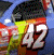Animated sequence shows a blue race car with number 42, featuring motion blur effects and multiple views of the vehicle.