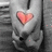 A pixelated heart-shaped icon with pink and red hues centered on a grayscale background featuring abstract shapes.