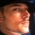 Pixelated close-up of a person's face in profile view with warm lighting and visible facial features including eyes, nose, mouth, and skin texture.