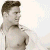 Static pixelated image of a shirtless male figure with short brown hair and visible facial features against a light background.