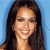 A static pixelated portrait of a person with long dark hair against a solid light blue background, showing a smiling expression.