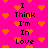 Pixelated pink background with orange hearts and black text reading "I Think I'm In Love" in two vertical