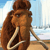 Pixelated image of a brown mammoth with long curved tusks standing against a light blue sky and sandy ground background.