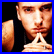 Two side-by-side pixelated frames of a person with visible facial features, tattoos, and clothing differences between the left and right images.
