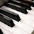 Static pixelated image of piano keys with black and white tones on a light background, no visible text or additional elements.
