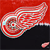 A pixelated red and white wing-shaped icon with a swirling pattern on a red and black background.