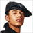 Pixelated image of a person wearing a black beret and dark clothing against white background, next to stylized 'B2K' text on black background.