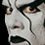 Pixelated close-up of a face with light skin tone, dark hair, and brown eyes showing partial facial features against black background.