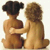Two pixelated figures in a seated embrace, one with dark hair, the other with light brown hair, both nude, against a plain background.