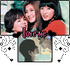 Animated sequence of two women in red tops embracing, with 'Love me' text and black heart symbols over a dotted star background.