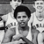 Black-and-white group photo of basketball players in uniforms with visible text, arranged in two with one player in the foreground holding a basketball