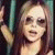 Two side-by-side pixelated images of a person with long hair and sunglasses, one static and one animated showing mouth open.