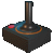 Pixelated joystick with brown vertical stick, dark base, blue and orange circular accents, red button on left side against gray background.