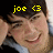 Pixelated image of a person with dark hair wearing a light blue shirt, overlaid with yellow text 'joe <3' at the top.