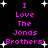 Black background with pink pixelated text reading "I Love The Jonas Brothers!" repeated twice, surrounded by white star shapes.