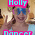 A person wearing blue sunglasses and a light blue top makes a peace sign with both hands, surrounded by colorful text overlays in pink, blue, green, and purple.
