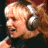 A pixelated image of a person wearing headphones with green text reading "Original Icons .com" on the right side against a dark background.