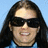 Pixelated image of a person with long dark hair and sunglasses, next to cyan text reading 'meet my favorite driver danica patrick!' on black background.