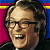 Pixelated portrait of a smiling person with glasses against a striped background of red, yellow, and blue sections.