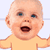 Pixelated static image of a baby's face with open mouth and raised arm, wearing yellow shirt against light background.