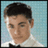 Static pixelated image of a person with dark hair, light skin, and a white shirt against a light blue background.