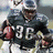 Pixelated image of a football player in dark jersey with number 36 holding a ball, alongside green with text
