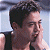 Pixelated image of a person with short dark hair wearing a sleeveless top, positioned next to green text reading 'Original Icons .com' on a solid background.