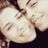 Two people smiling closely together in a sepia-toned image with visible pixelation and slight blurring.
