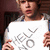 A pixelated image shows a person in a white shirt with gray patterns holding a sign, next to green text reading 'Writer Grl 101' on a white background.