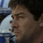 Pixelated close-up of a person's face in profile, showing dark hair, closed eyes, and a light-colored shirt against a blurred background.