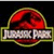 Pixelated red circular logo with yellow border above silver banner reading 'JURASSIC PARK' on black background.
