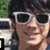 A person with dark hair and white sunglasses appears in a split-screen view, with text overlays reading "joe jonas" and "><33" on the right side.