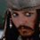 Pixelated image of a character with long dark hair, silver earrings, and a gray head covering showing three distinct facial expressions.
