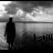 Silhouette of a person standing against cloudy sky background with changing text below in blue and purple hues.