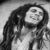 Black-and-white pixelated static image of a person with long hair and facial features, likely from an old digital icon or low-resolution photo.