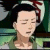 Static pixelated image of a person with closed eyes, dark hair, and light skin wearing a green garment against a blurred background.