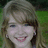 A pixelated image of a smiling person with light brown hair against a green background, next to green text on a purple background.