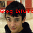 A pixelated image of a person with dark hair in a black hoodie, with red text overlays reading 'Greg DiTullio', 'Stay Strong', and 'We're Praying For You!' across different sections.