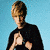 A person with light brown hair in a black shirt against a blue background, shown across four with varying hand positions and head angles