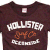 A static image shows a dark brown T-shirt with 'Hollister' text and orange graphic, next to maroon background with white handwritten-style text reading 'Hollister Hater DEAL WITH IT!'.