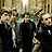 A 48x48 pixel buddy icon featuring a static image of three men in dark clothing with blurred faces, accompanied by text promoting "Matchbox Twenty" and store availability.