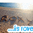 Beach scene with footprints in sand, blue water background, and partial text overlay reading '...is love' on a white banner.