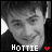 Six grayscale show a person's face with varying expressions and text below each ; the word 'HOTTIE' appears in white pixelated font next to a red heart symbol