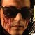 Pixelated close-up of a person's face with dark sunglasses and a light brown cap, cropped tightly around the eyes and nose.