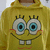 Yellow hoodie with Spongebob Squarepants face printed on front, featuring large blue eyes, two square teeth, and red cheeks.