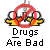 Pixelated cartoon duck with red prohibition symbol over its head, yellow beak and feet, white eyes with black pupils, gray background, text 'Drugs Are Bad' below.