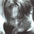 A pixelated grayscale image of a person's face with dark hair, partially obscured by low resolution and compression artifacts.