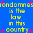 Blue background with yellow pixelated text repeating 'is the law in this country' and pink starbursts scattered throughout.