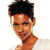 Pixelated close-up of a person with short dark hair, light skin, and a white shirt, facing slightly left against a plain background.